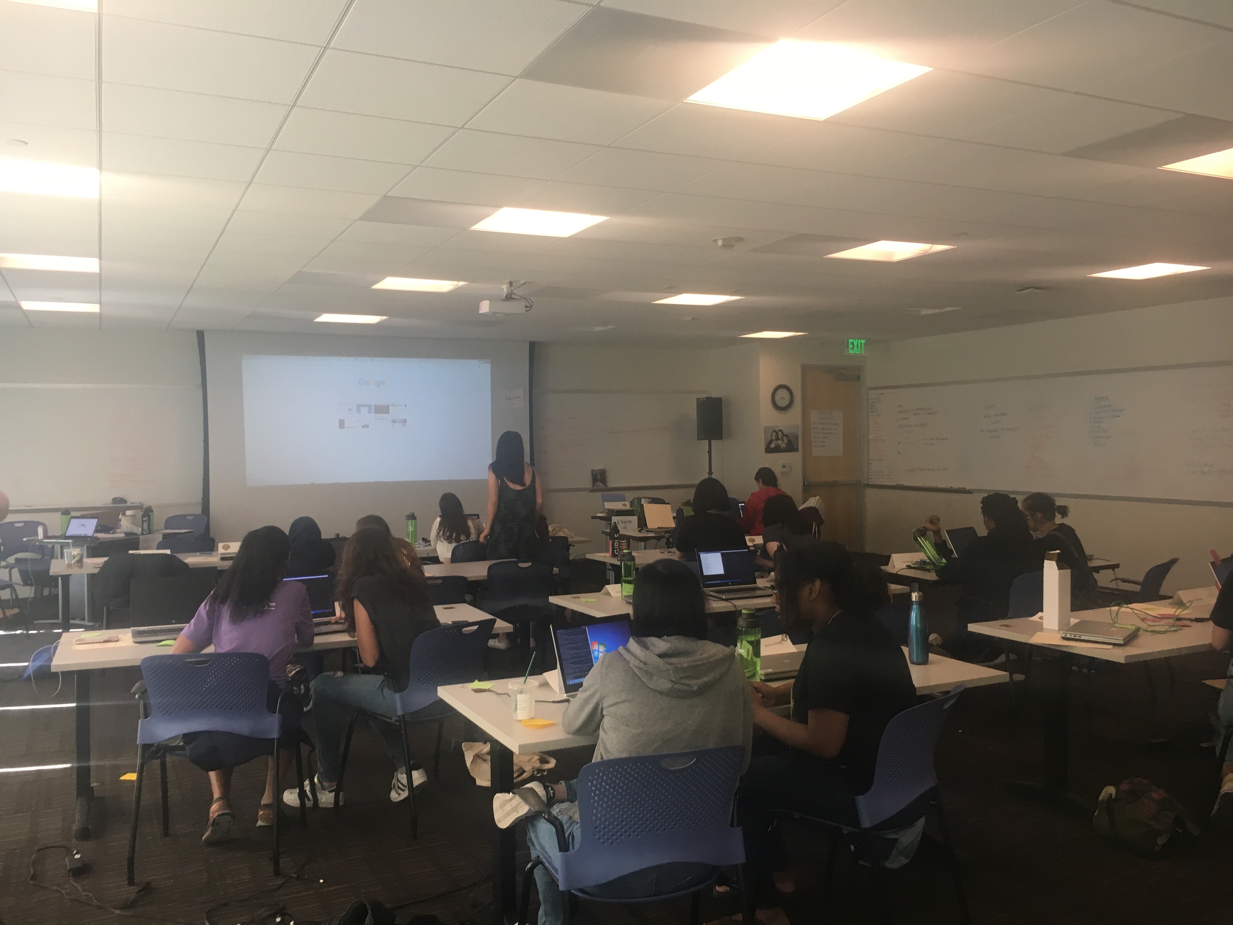 The class working at their desks to write a ChatBot program in Python