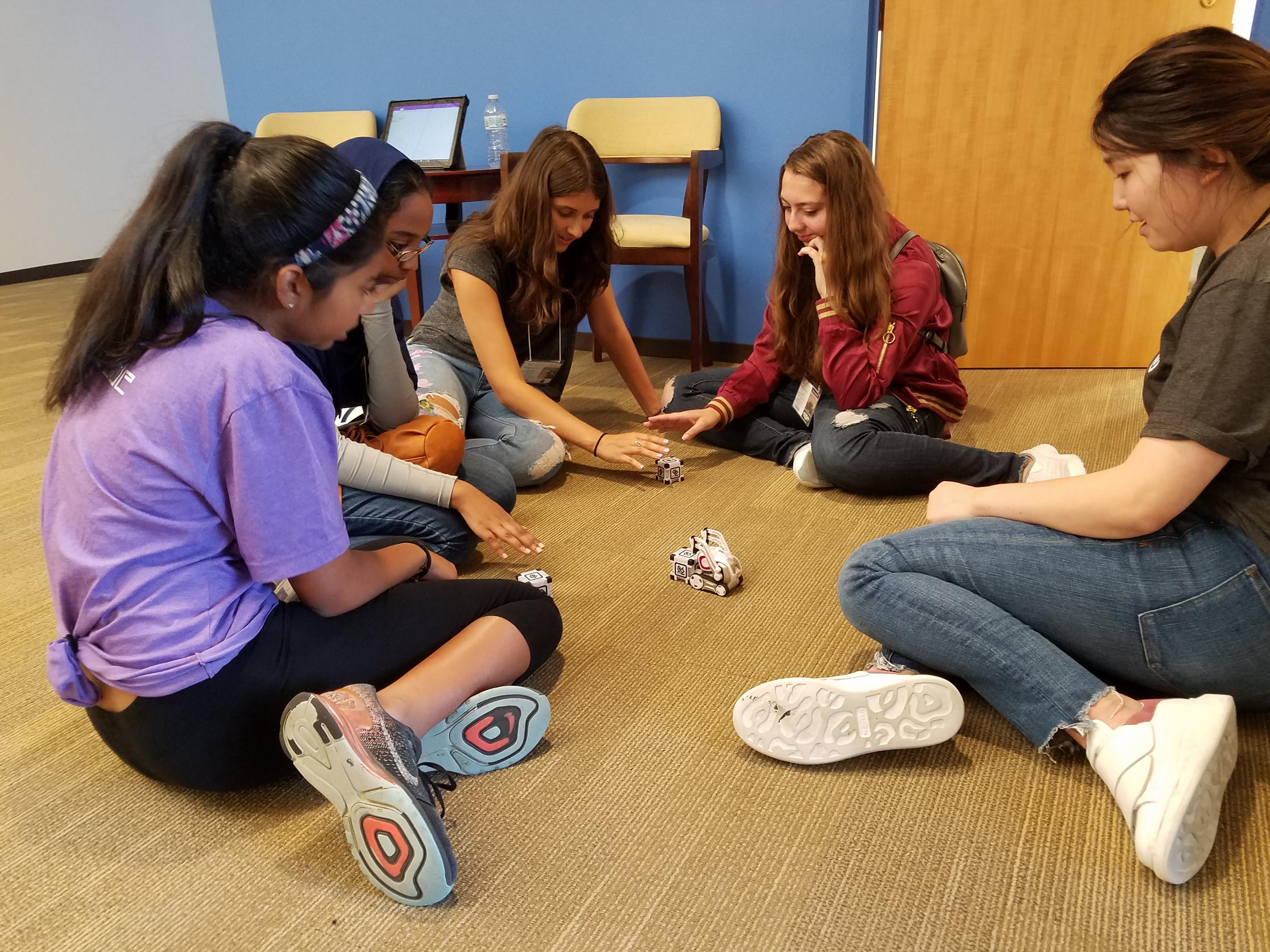 Students playing with Cozmo Robot during a field trip